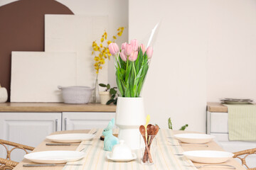 Poster - Vase with tulips and Easter rabbit on dining table in kitchen