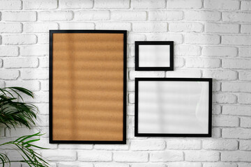 Wall Mural - Black picture frame hanging on white brick wall copy space