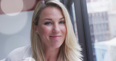 Sticker - Image of spotlights over caucasian businesswoman in office