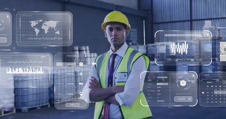 Wall Mural - Image of data processing on screens over biracial man working in warehouse