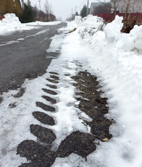 Wall Mural - Snow on an asphalt road in winter