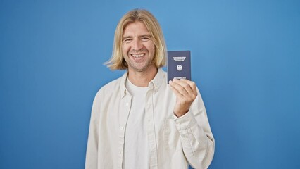 Sticker - Blond man holding german passport against blue background smiling