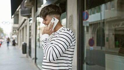 Poster - Happy urban snap, confident young hispanic guy enjoying a fun, sunny outdoor chat on his smartphone, standing on city street, flashing a cool, attractive smile.