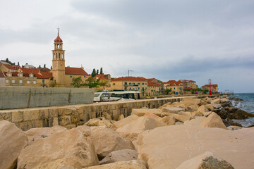 Wall Mural - The waterfront of the historic village of Sutivan on Brac Island in Croatia. The Church of the Assumption of the Blessed Virgin Mary is background left