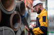 © Nassorn - Industrial engineer in safety helmet uniform jacket working in heavy steel engineering factory. Technician manager worker inspector using laptop in metalwork product manufacturing facility workplace