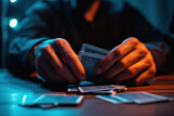 Fototapeta  - Close-up of hands skillfully handling playing cards, with a moody, dimly lit ambiance.