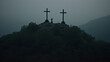 Three crosses sit on top of a hill, creating a dark graveyard scene in the fog.