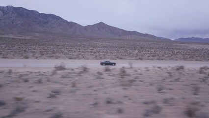 drone footage following dodge challenger near red rock canyon, united state