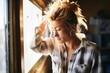 person squinting at sunlight through window, messy hair