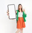 © sitthiphong - Cheerful beautiful Asian women wear colorful clothes and holding smartphone mockup of blank screen and shows ok sign on white background.