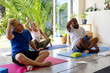 © Wavebreak Media - Focused diverse seniors exercising in pilates class