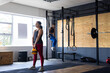 © Wavebreak Media - Caucasian young women exercising with kettle bell and gymnastic rings in health club, copy space