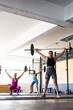 © Wavebreak Media - Diverse young females lifting barbells while exercising in health club, copy space