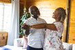 © Wavebreak Media - Happy senior african american couple dancing in living room