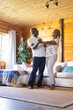 © Wavebreak Media - Happy senior african american couple dancing in living room