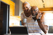 © Wavebreak Media - Senior african american couple doing paperwork using tablet at home