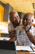 © Wavebreak Media - Senior african american couple doing paperwork using tablet at home