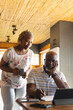 © Wavebreak Media - Senior african american couple doing paperwork using tablet at home
