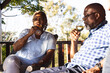 © Wavebreak Media - Senior african american couple drinking wine on sunny terrace