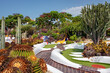 Spectacular green xeriscape garden, beautiful outdoor green space surrounding a mini golf area, featuring a large variety of tropical flora: cacti, succulents, drought-tolerant shrubs and perennials