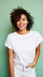 © Synthetica - Young happy smiling Latin woman model wearing tshirt standing on color background. Face skin treatment, curly hair care cosmetics makeup, fashion ads. Beauty portrait. White t-shirt mock up template .