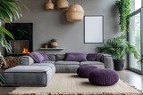 Fototapeta Uliczki - Cozy Scandinavian living room with knitted pouf, grey sofas adorned with purple pillows, and fireplace against a stylish grey wall.