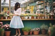 lady in a pastel skirt selecting flowers at a garden center