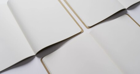 Sticker - Close up of open blank books with copy space on white background in slow motion