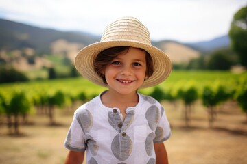 Poster - Portrait of a smiling little girl in a straw hat in a vineyard