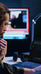 Vertical video Experienced programmer writes code on laptop screen while in apartment office using Java programming languages. Developer remotely working on fixing database errors while working from