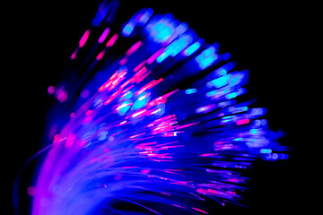 Wall Mural - Close up of blurred light fiber optics for communication technology network