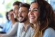 © Chand Abdurrafy - Close-up expressions of a staff or participant group thoroughly enjoying a startup business presentation, emphasizing the positive and vibrant atmosphere