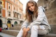 © Nerea - Portrait of a beautiful young woman sitting on the steps of a building