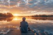 © mariyana_117 - Image of a senior person sitting on a dock, dipping their feet in the water, watching the sunrise over a calm lake.