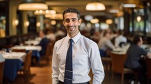 Smiling restaurant manager ensuring every guest feels valued