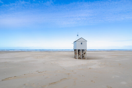 a wooden shelter on high stilts that stands on the north sea beach (de drenkelingenhuisje) the dutch