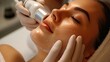 © AdriFerrer - Close-up of a facial skincare procedure with a machine on a woman's face.