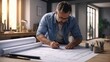© UniquePicture - Architect working on blueprints