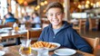 © Ilja - Happy preteen enjoying waffle fries in restaurant with blurred background and copy space