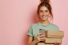 Young Happy Woman Wear Green Shirt White T-shirt Hold In Hand Brown Clear Blank Craft Stack Cardboard Boxes Mock Up Use Mobile Cell Phone Isolated On Plain Pastel Light Pink Background