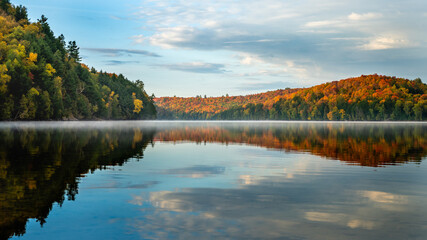 Wall Mural - Lake and Forest in soft morning light with beautiful fall colour and reflections of the sky