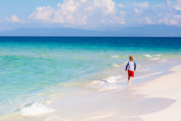 Wall Mural - Kids playing on beach. Children play at sea.