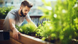 Young urban man looking at aromatic herbs in a wooden raised bed with fresh green herbs standing on a balcony garden