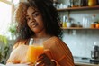 health care Plus-sized woman with a glass of juice while standing in the kitchen