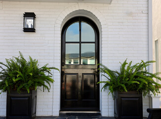 Wall Mural - White brick building with black Dutch door