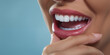 © IBEX.Media - Close-up on beautiful teeth of caucasian woman with hand touching her chin