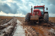 Dirty Workhorse: Tractor Navigating Muddy Landscape