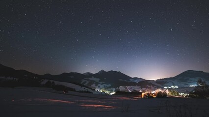 Wall Mural - stars time lapse in blue night sky over alpine nature in winter countryside
