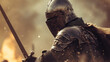 medieval knight wearing metal armor holding sword on blur background of war