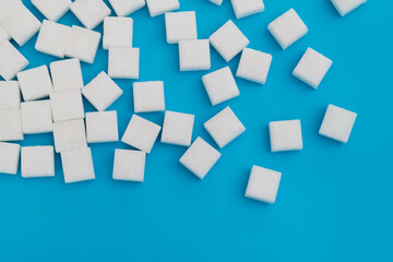 Wall Mural - Sugar cubes on blue background